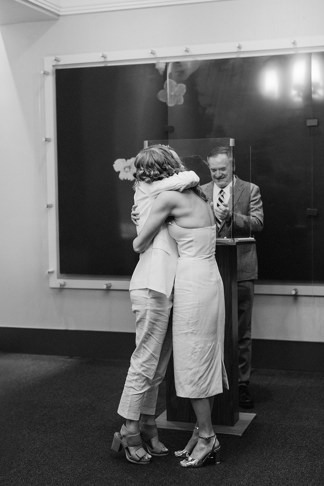 Couple hugging after their civil ceremony in the New York City Hall