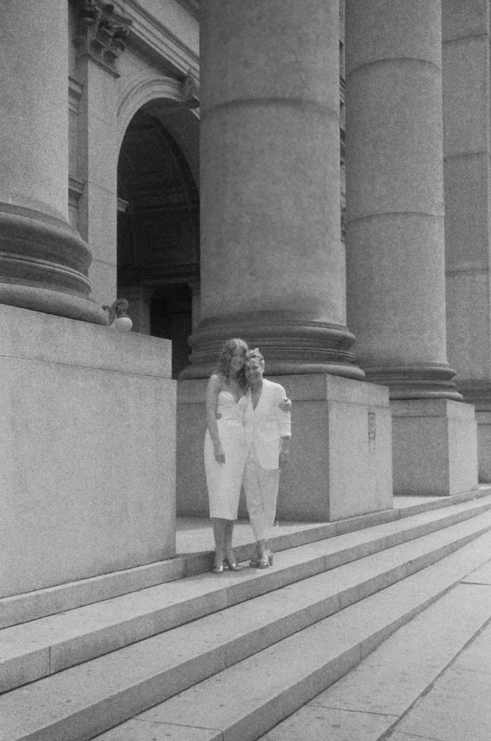 Film wedding photo of couple on the steps of the New York City Hall