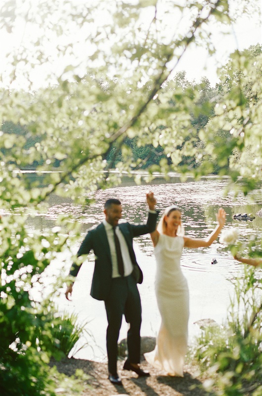 Blurry photo of bride and groom happily dancing to celebrate their Brooklyn elopement