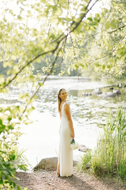 Photo of bride at waterfront ceremony site in Prospect Park wedding
