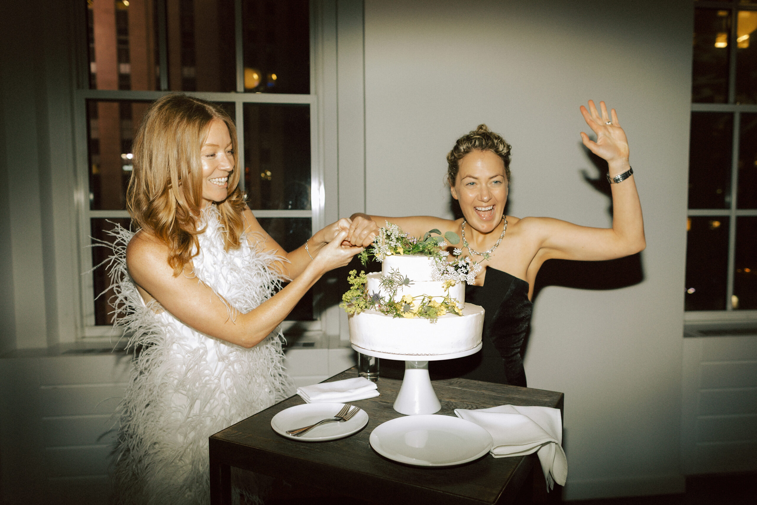 Wedding cake cutting photo from Catie and Jane's NYC wedding reception