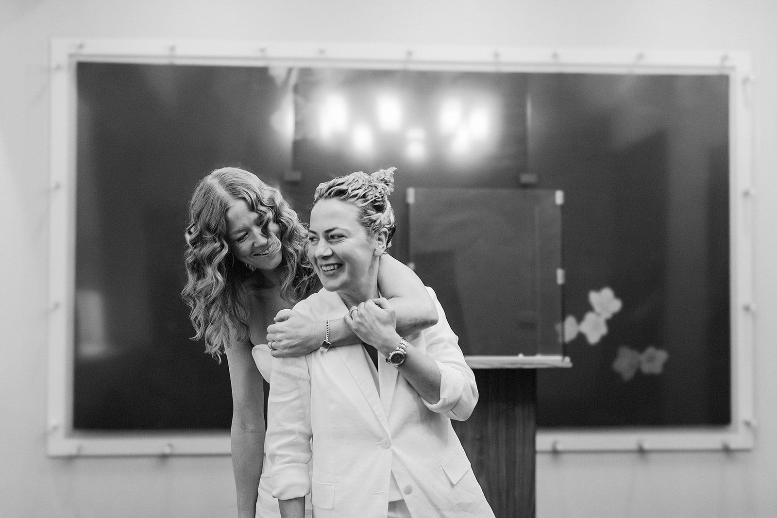 New York same sex wedding photo of two brides celebrating after their civil ceremony at the New York City hall.