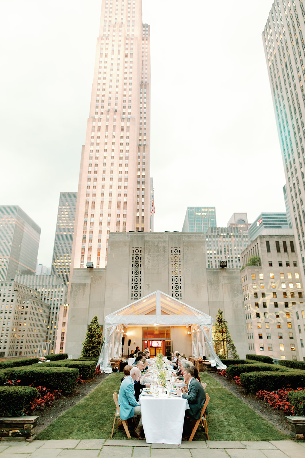 Rockefeller center wedding reception, photo of family at table with New York City skyline in the background